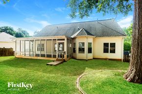 Concord house for rent - a white house with a porch and a grass yard