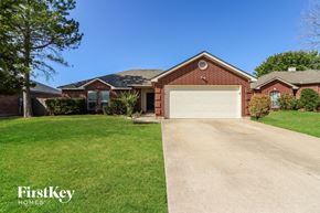 Saginaw house for rent - a clean driveway in front of a house with a garage door