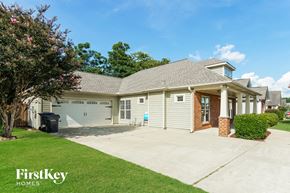 Calera house for rent - a white house with a driveway and a garage door