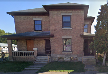 Zanesville apartment for rent - a brick house with a porch and a bike parked in front of it