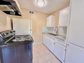 Bay City house for rent - a kitchen with a stove and refrigerator and a sink