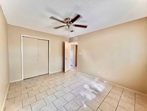 Bay City house for rent - an empty living room with a ceiling fan and tiled floors