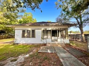 Bay City house for rent - the front of a small white house with a porch