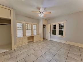 Bay City house for rent - an empty living room with a ceiling fan and a window