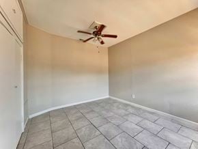 Bay City house for rent - the living room has a ceiling fan and a tiled floor