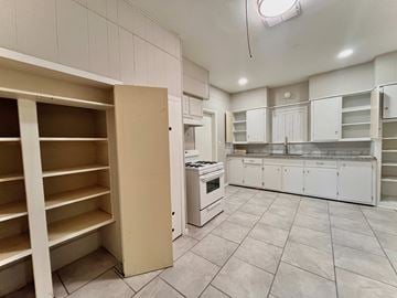 Bay City house for rent - a kitchen with white cabinets and a stove and a counter top