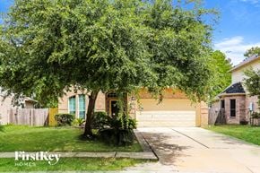 Spring house for rent - A tree in front of a house with a garage door.