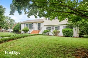 Monroe house for rent - a white house with a yard in front of it