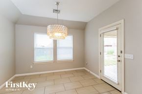 Edmond house for rent - a dining room with a chandelier and two windows
