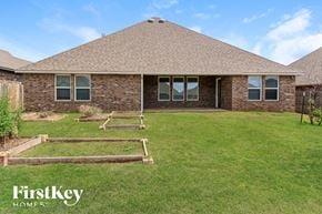 Edmond house for rent - the backyard of a house with steps in the grass