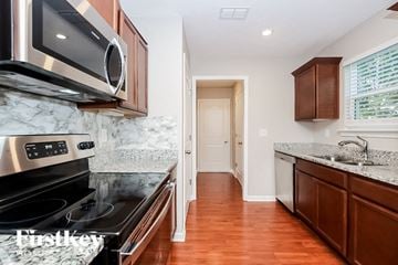 Antioch house for rent - A kitchen with a stove top oven and microwave above it.