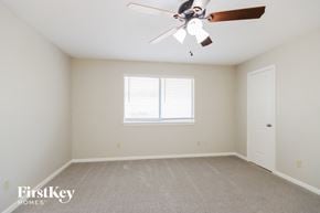 Kingwood house for rent - a bedroom with a ceiling fan and a window