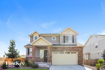 Aurora house for rent - a brick house with a white garage door