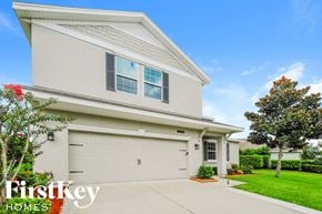 Green Cove Springs house for rent - a white house with a garage door and a lawn