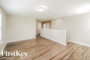 Green Cove Springs house for rent - the living room and dining room with wood flooring and white walls
