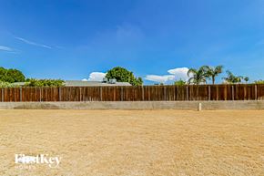 Glendale house for rent - A wooden fence in the foreground with a blue sky and some trees in the background.