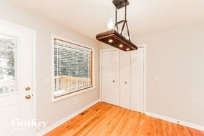 Cumming house for rent - a living room with wood floors and a large window and a closet