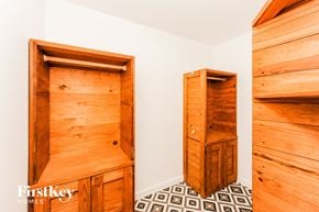 Cumming house for rent - a walk in closet in a bedroom with wooden cabinets