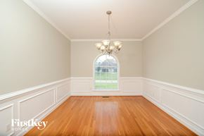 Advance house for rent - a dining room with a large window and wooden floors