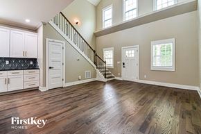 Atlanta house for rent - an open living room with white cabinets and a staircase