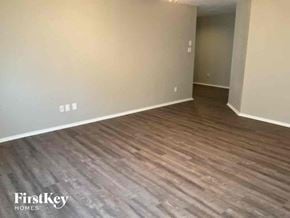 Fort Worth house for rent - a living room with hardwood flooring and white walls