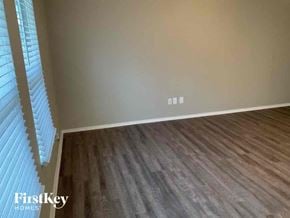 Fort Worth house for rent - an empty room with wood floors and a window