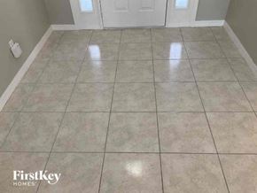 North Port house for rent - a tiled floor in a room with a door