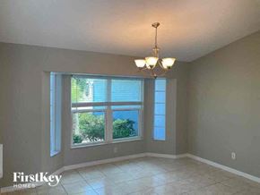 North Port house for rent - a dining room with a large window and a chandelier