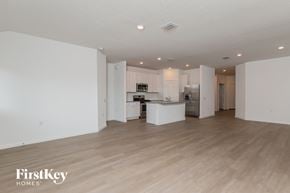 San Antonio house for rent - A spacious kitchen and living room with wooden floors and white walls.