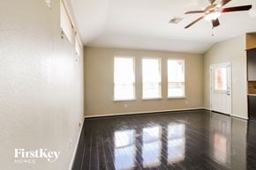 Katy house for rent - A room with a fan and a door.