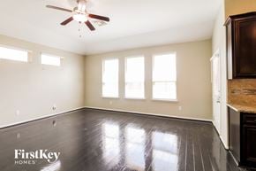 Katy house for rent - A room with a wooden floor and a ceiling fan.
