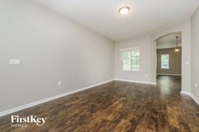 Lakeland house for rent - A room with wooden floors and a doorway leading to another room.