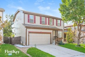 Parker house for rent - a home with a garage door and a driveway