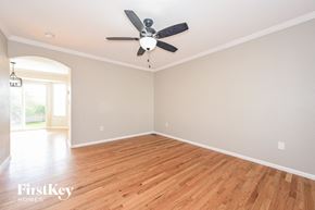 Parker house for rent - the living room with hardwood floors and a ceiling fan