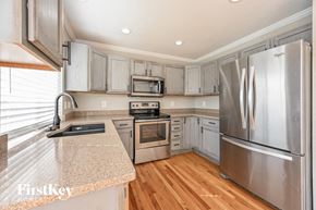 Parker house for rent - a kitchen with stainless steel appliances and granite counter tops