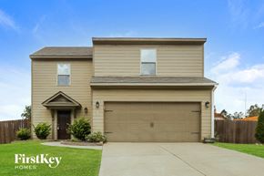 Cartersville house for rent - a house with a garage door and a driveway
