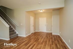 Cartersville house for rent - a empty living room with a wooden floor and stairs