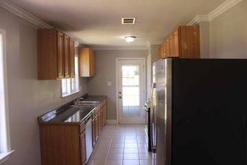 Purvis house for rent - a kitchen with a refrigerator and a sink