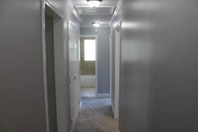 Purvis house for rent - a hallway with a door to a bathroom and a closet with a window