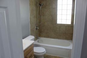Purvis house for rent - a bathroom with a tub and a toilet and a sink
