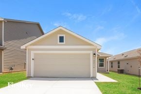 San Antonio house for rent - a white garage door in front of a house