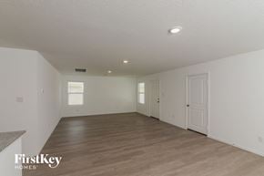 San Antonio house for rent - the living room and dining room of a house with a wood floor