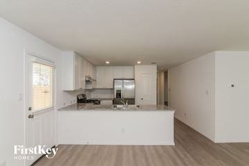 San Antonio house for rent - a kitchen with white cabinets and a counter top