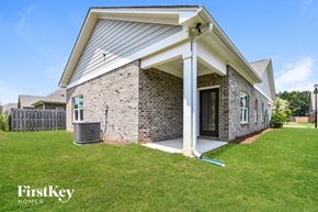 Gardendale house for rent - a brick house with a covered porch and a grass yard