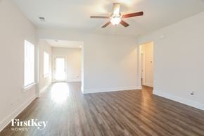 Gardendale house for rent - an empty living room with white walls and a ceiling fan
