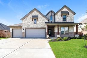 Mont Belvieu house for rent - A two-story house with a garage and a driveway.