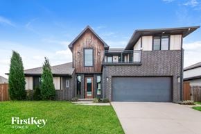 Edmond house for rent - A modern house with a garage and a driveway.