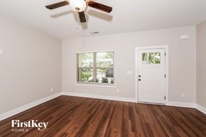 Irondale house for rent - an empty living room with a ceiling fan and a window