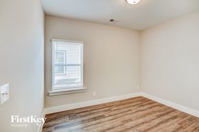 Irondale house for rent - a bedroom with a wood floor and white walls and a window