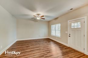 Irondale house for rent - an empty living room with wood floors and a ceiling fan